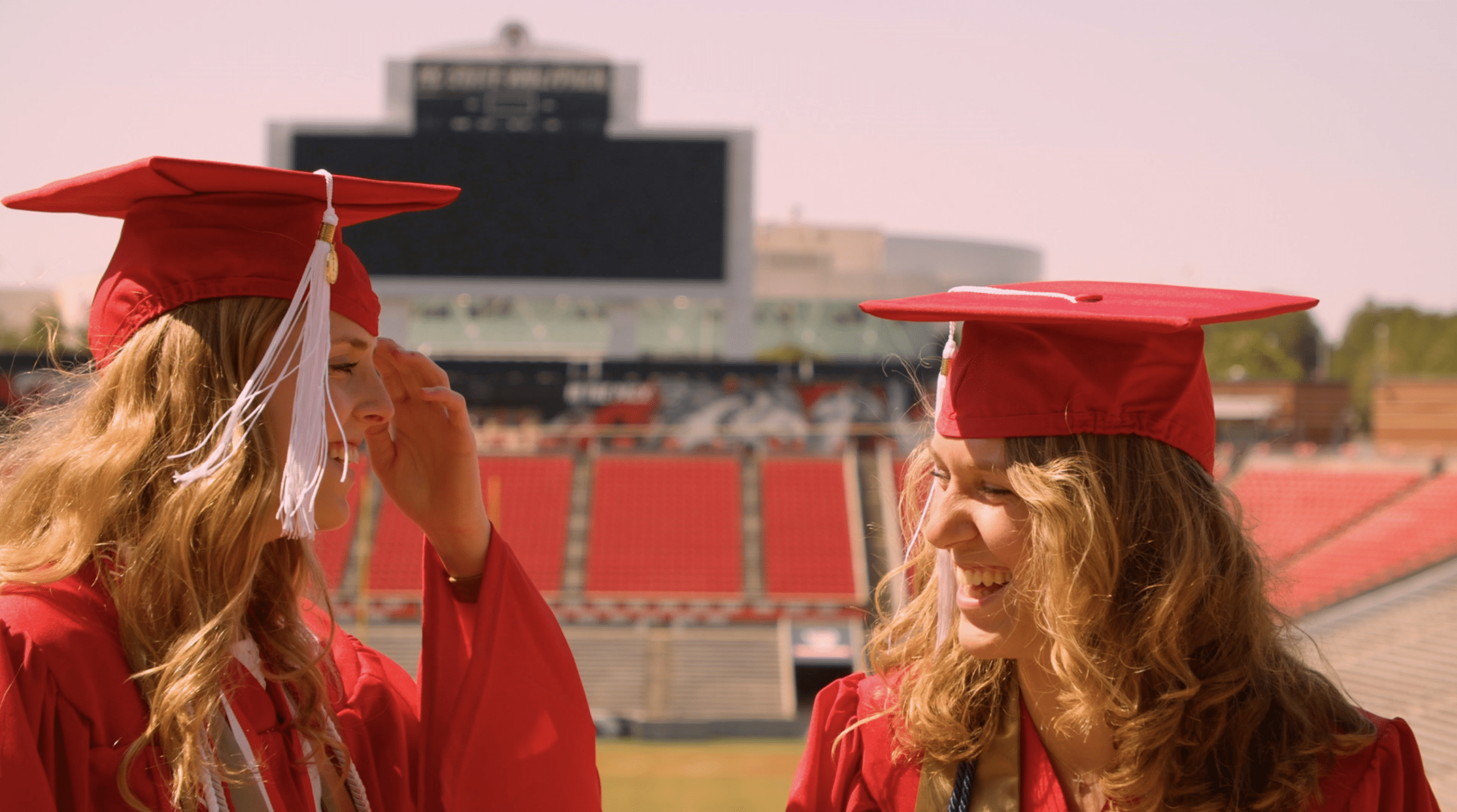 Alyssa McInnis and Emily Southard pose in their graduation caps and gowns