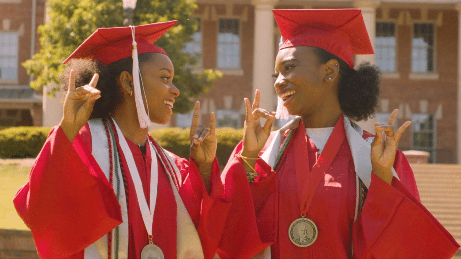 Niambé James and Kourtni Curry pose in their graduation caps and gowns